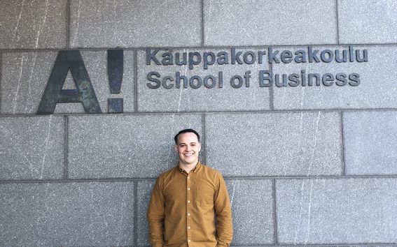 The picture shows doctoral student Hunter Jones in the front of the School of Business. The photo comes from Hunter Jones.  