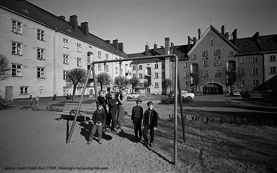 Black and white image from museum archives presenting children on a yard playing