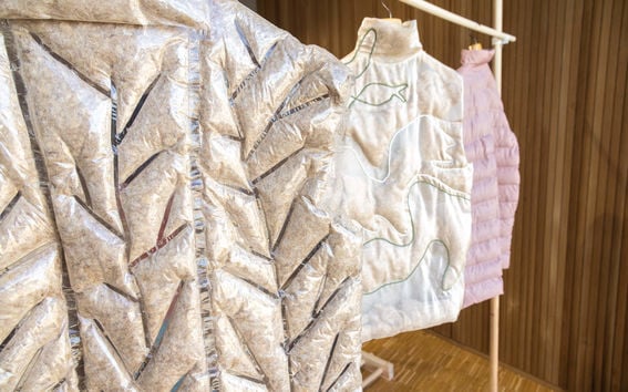 Three pieces of Fluff Stuff outerwear hanging on a rack.