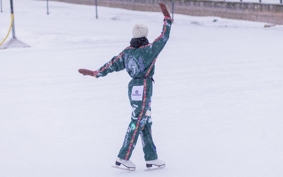 The picture shows a person skating in a wintry landscape.