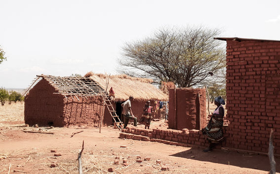 Buildings being constructed of red tiles in a very dry landscape in Zanzibar