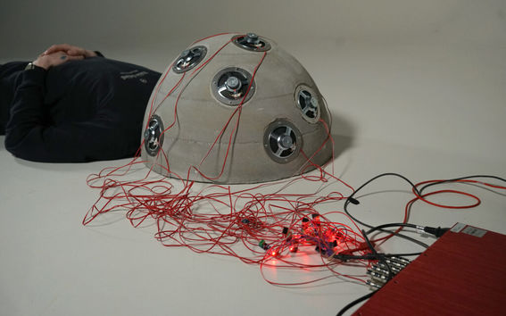 Some kind of electronic helmet linked to another device.