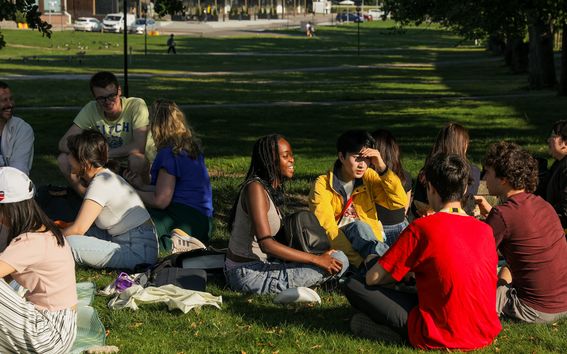 A group of Aalto University Summer School students during a welcome picnic in the park outside Aalto University campus.