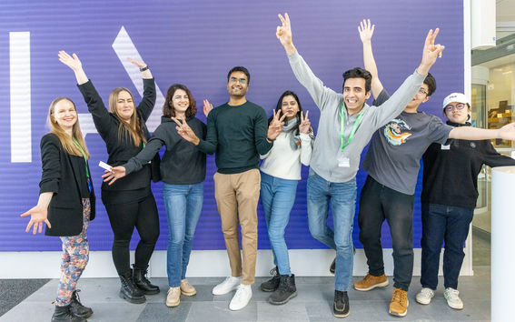 Students standing in line with their hands up at the Nokia headquarter lobby