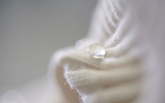 A drop on liquid on white fabric