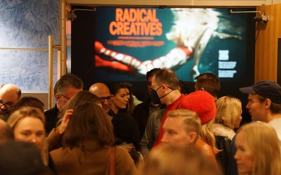 A crowd of people gathering to the theatre lobby after seeing the Radical Creatives documentary