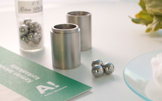 Photo of stainless steel milling jars and balls, and biomaterials cotton and branch.
