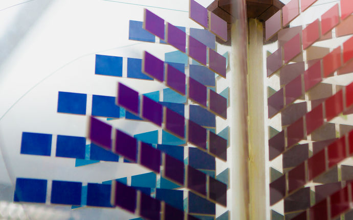 Abstract image with several small square pieces in blue, aubergine and red. Photo by Aalto University / Mikko Raskinen