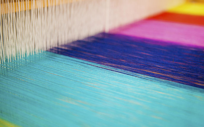 ARTS studio with a close-up on colourful yarns on a loom, image by Mikko Raskinen