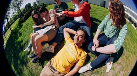 6 students sitting outside of Aalto University library