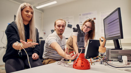 students testing a robotic hand