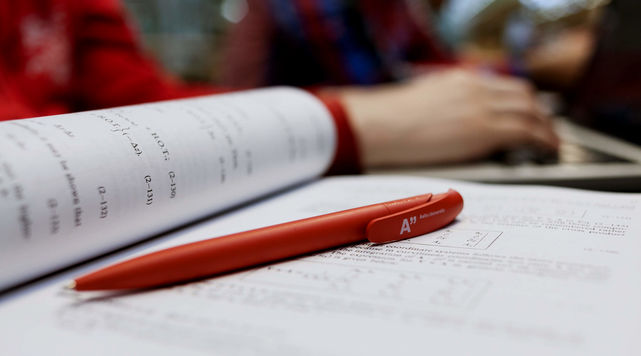 Aalto University red pen and notebook