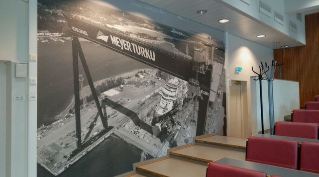 A picture of the Meyer shipyard on the wall of a company-sponsored lecture hall.