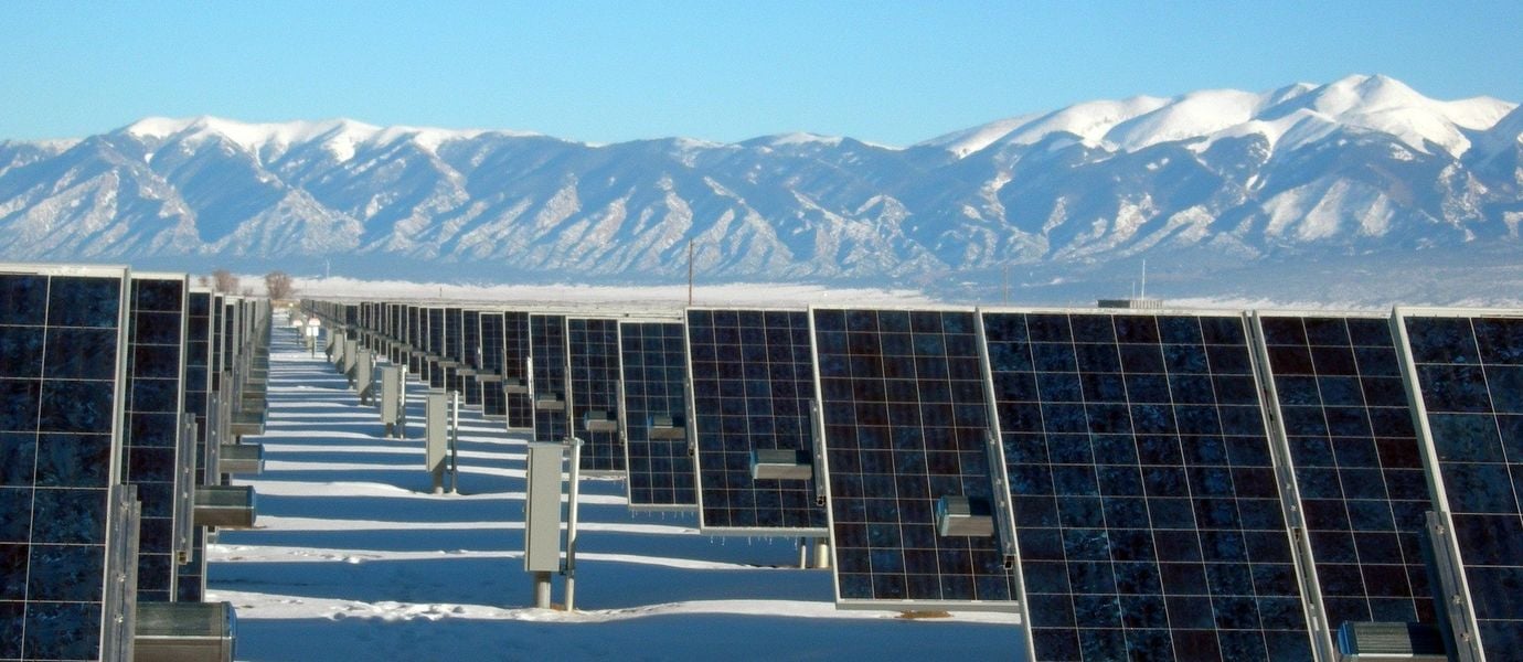 Solar panels in front of mountains