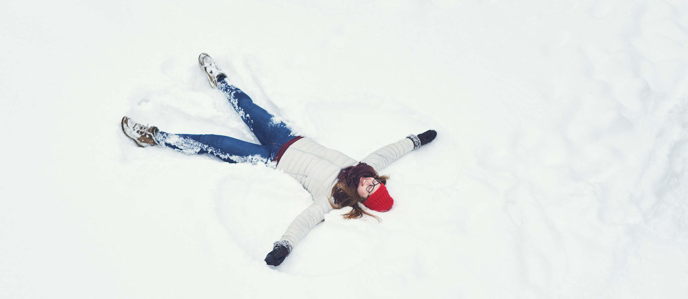 Student lying on snow, making stars. Photo by Aalto University / Unto Rautio