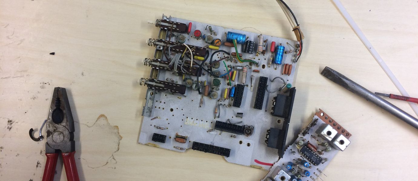 Disassembled circuit board with pliers