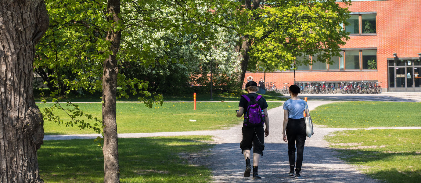 Two people walking on campus.
