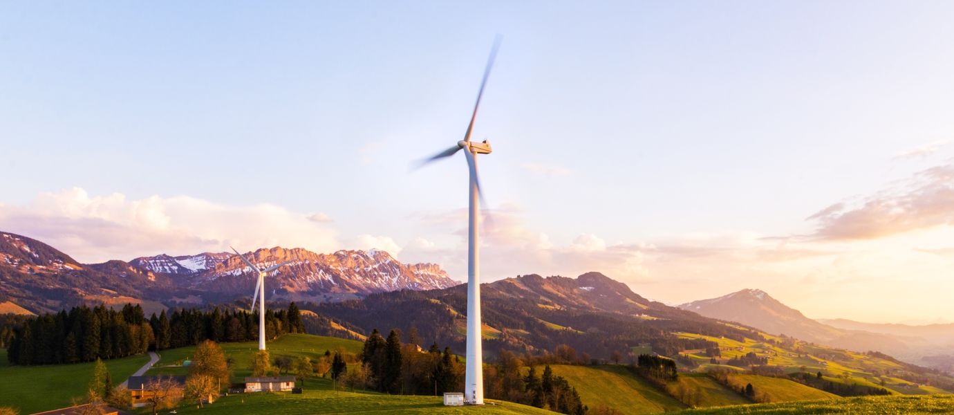 Two wind power plants in an alpine landscape