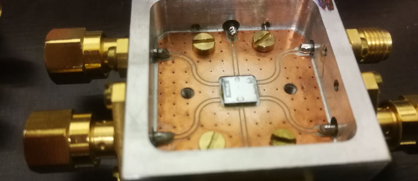 A small microchip containg quantum circuitry inside a metal sample holder