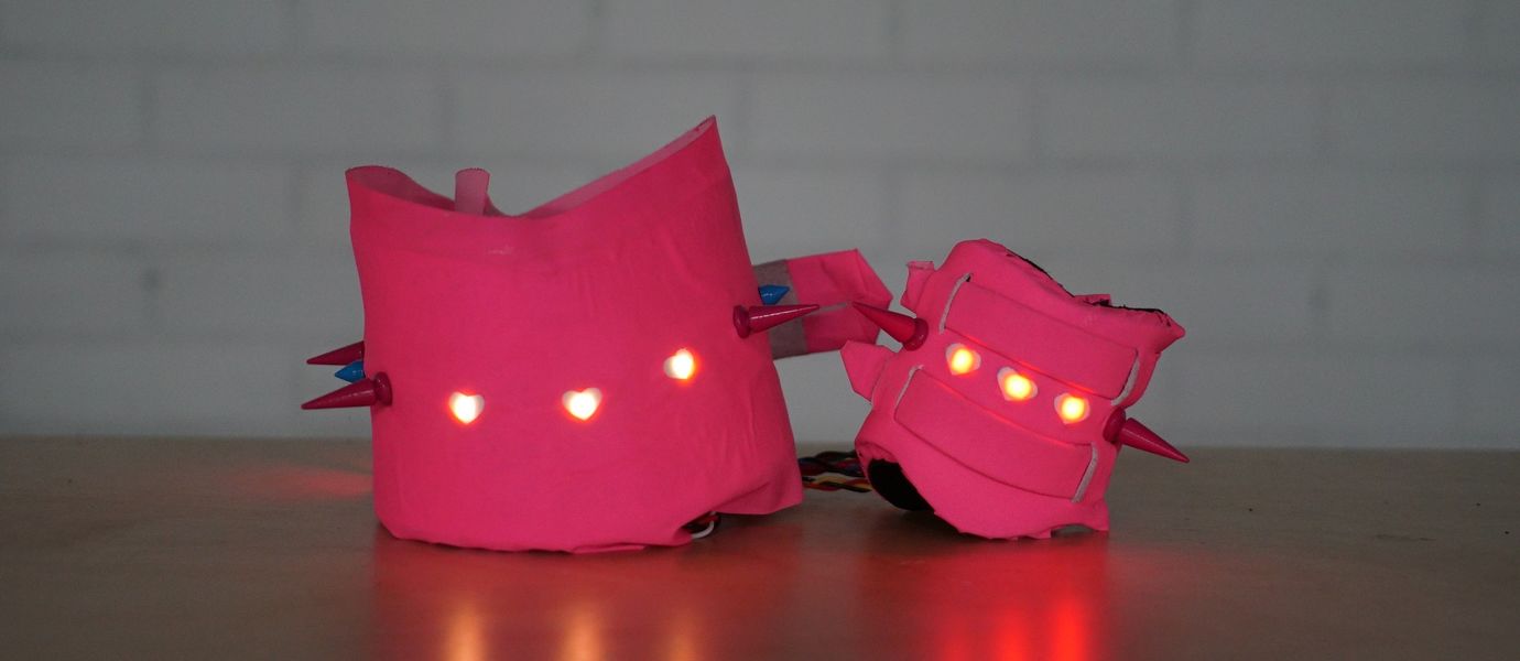 two pink objects with lights in the middle