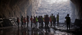 A group of people gathered at the metro construction site underground in Otaniemi
