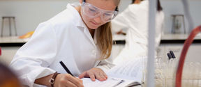 An image of a student making calculations on paper
