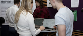 Young people looking some information together over a computer