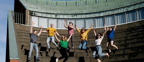Students jumping for joy at the Amphitheater stairs.