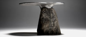 a side table / sculpture made of natural stone and cast aluminium