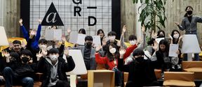 Group picture of students from UNIST university holding their diplomas and wearing face masks in A Grid building, Aalto University.