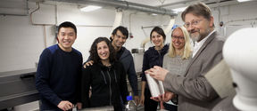 Professor Emeritus Herbert Sixta and members of the Ioncell team posing beside a Ioncell spinning machine