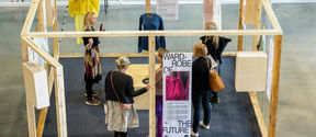 people exploring the walk-in closet that provides solutions for a sustainable fashion and textiles future