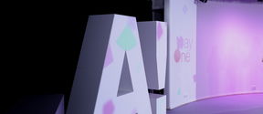 Aalto logo standing in purple coloured lights