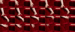 A grid made up of variations of the same photograph. Each of the photographs shows a progression of a hand caressing a red, velvet armchair.