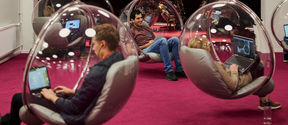 People sitting in bubble chairs