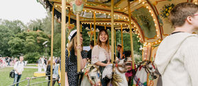 Students riding a carousel during the opening day of the semester