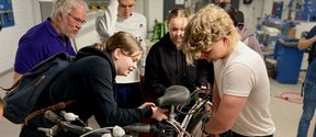 Students pull a bicycle apart