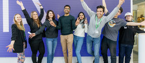 Students standing in line with their hands up at the Nokia headquarter lobby