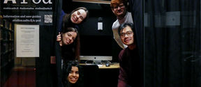 Five students posing in a mini podcast studio at Aalto University