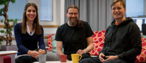 Lara Ejtehadian, Patrick Rinke, and Ilari Lähteenmäki sitting with coffee mugs and smiling to the camera.