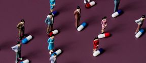 Small human figures each standing in front of a pill
