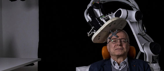 A man sitting in a brain imaging machine