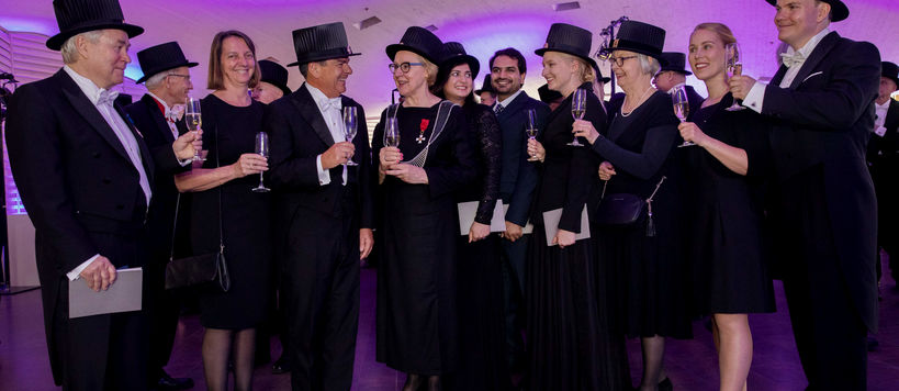 A group of doctors toasting at a Conferment party.