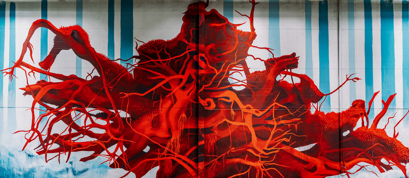 Saara Salmi painting in Keran Hallit. Deep red roots spread out across the wall