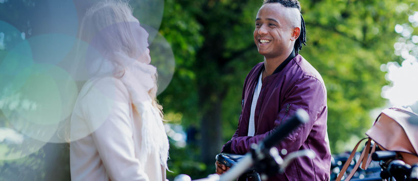 Students talking outside by their bicycles. 
