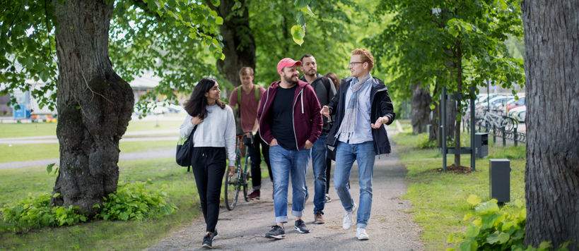 Aalto students walking at campus during summer
