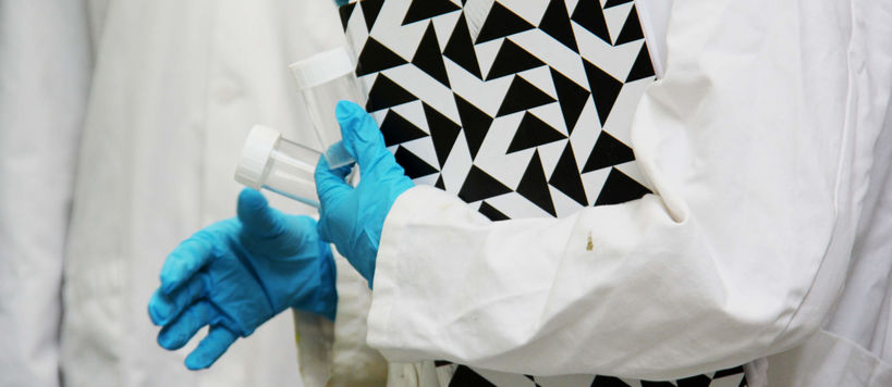Lab coat, folder and lab gloves. Photo by Aalto University, Kitty Norros