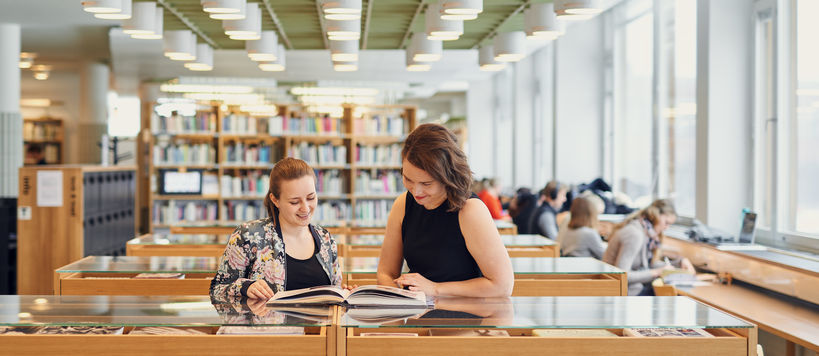 Two women reading in the library