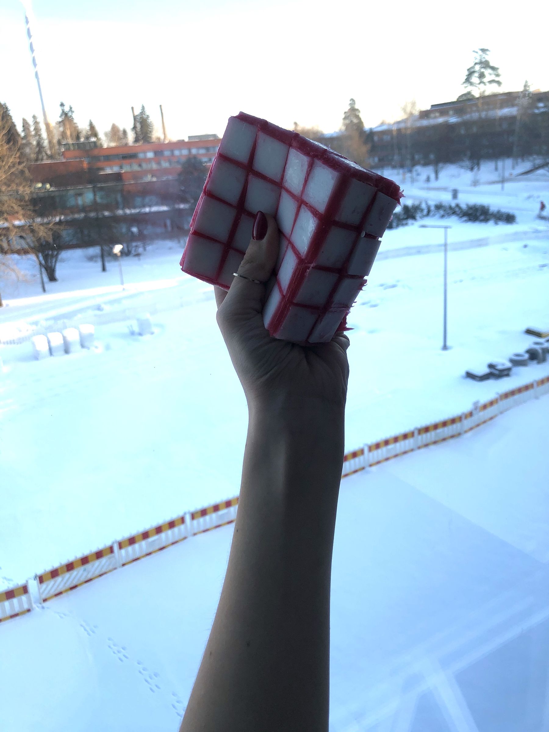 hand squeezing a foamy cube