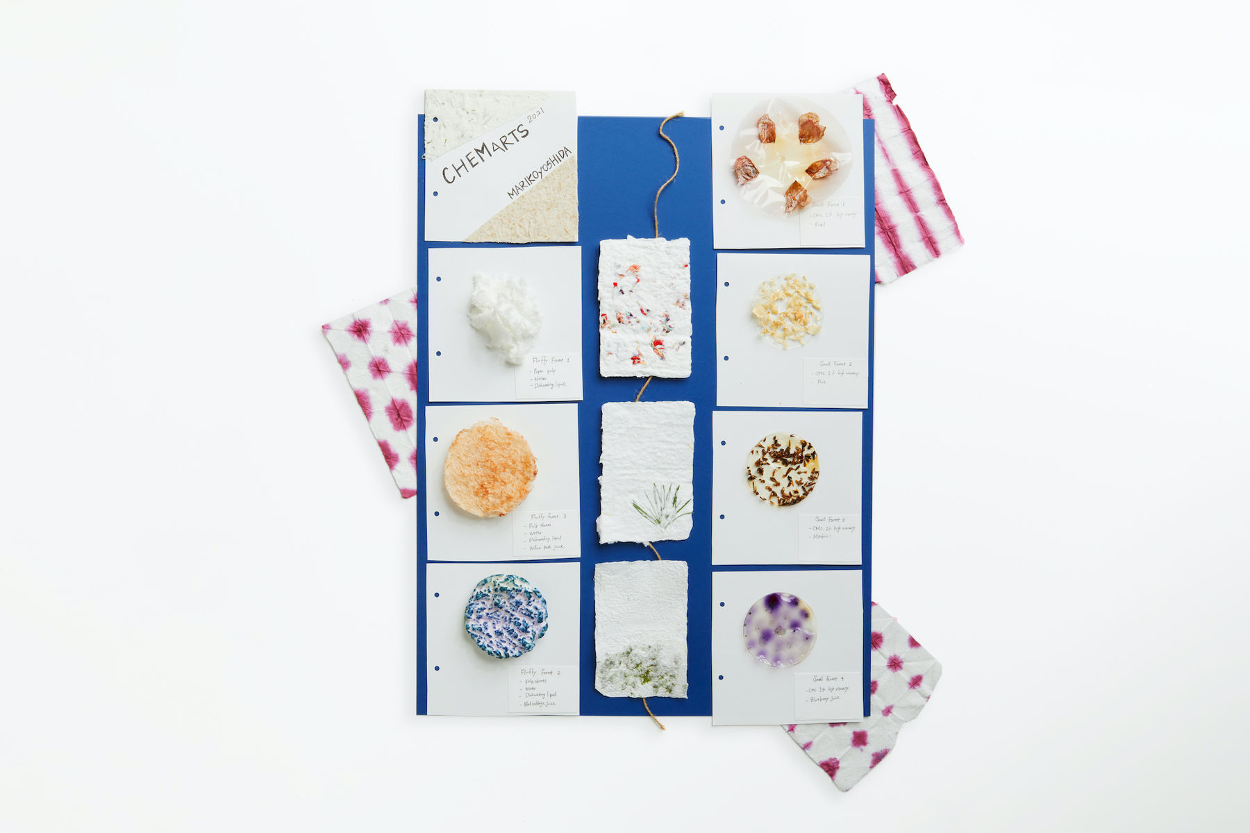 Portfolio photo of different items produced through experiments during Aalto University Summer School course Nordic Biomaterials with CHEMARTS. The times are laid out on a blue background and photographed from above. The times are different types of foam and paper made out of biomaterials like cellulose.